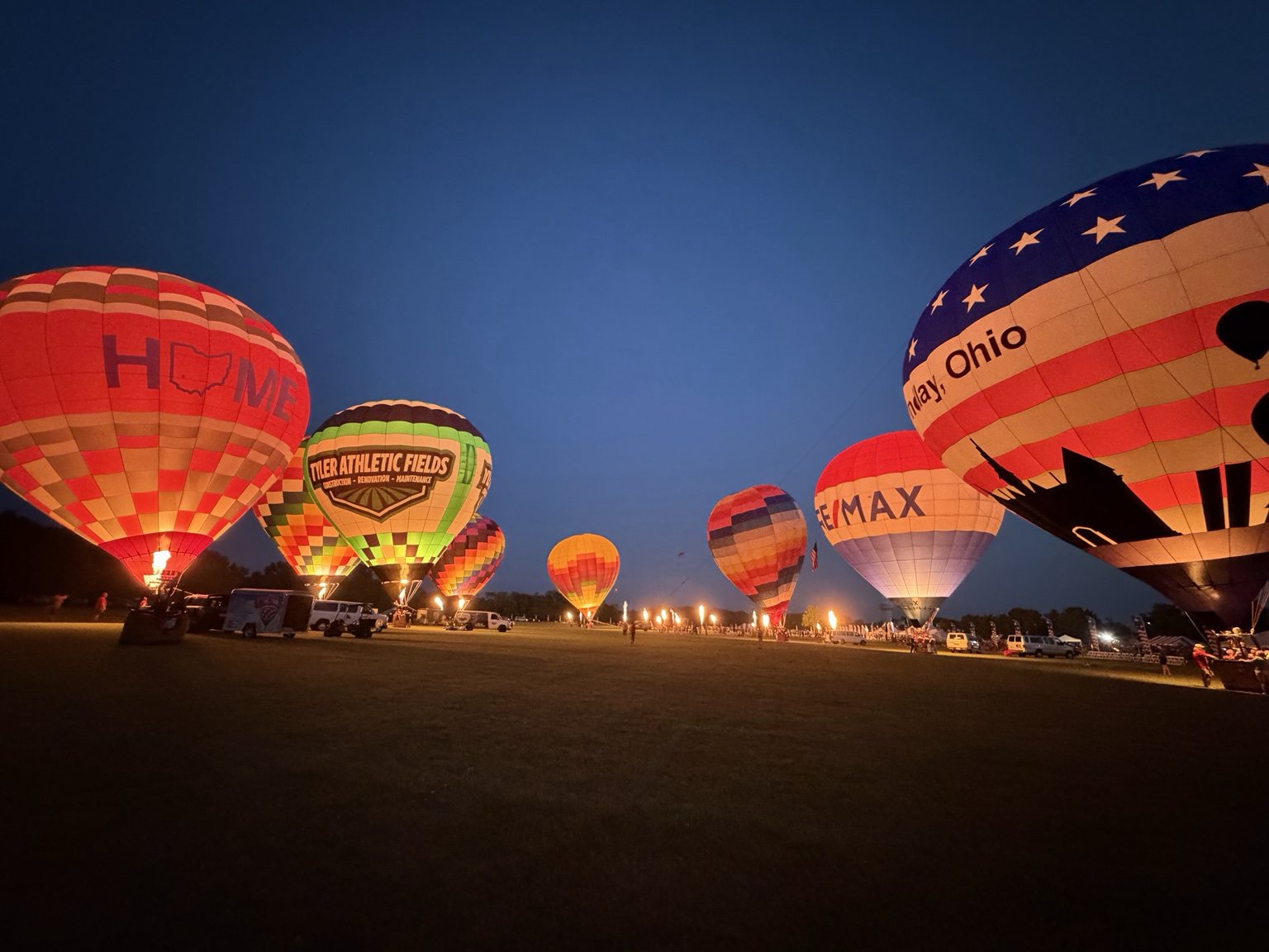 Row of balloons lit up at a night glow