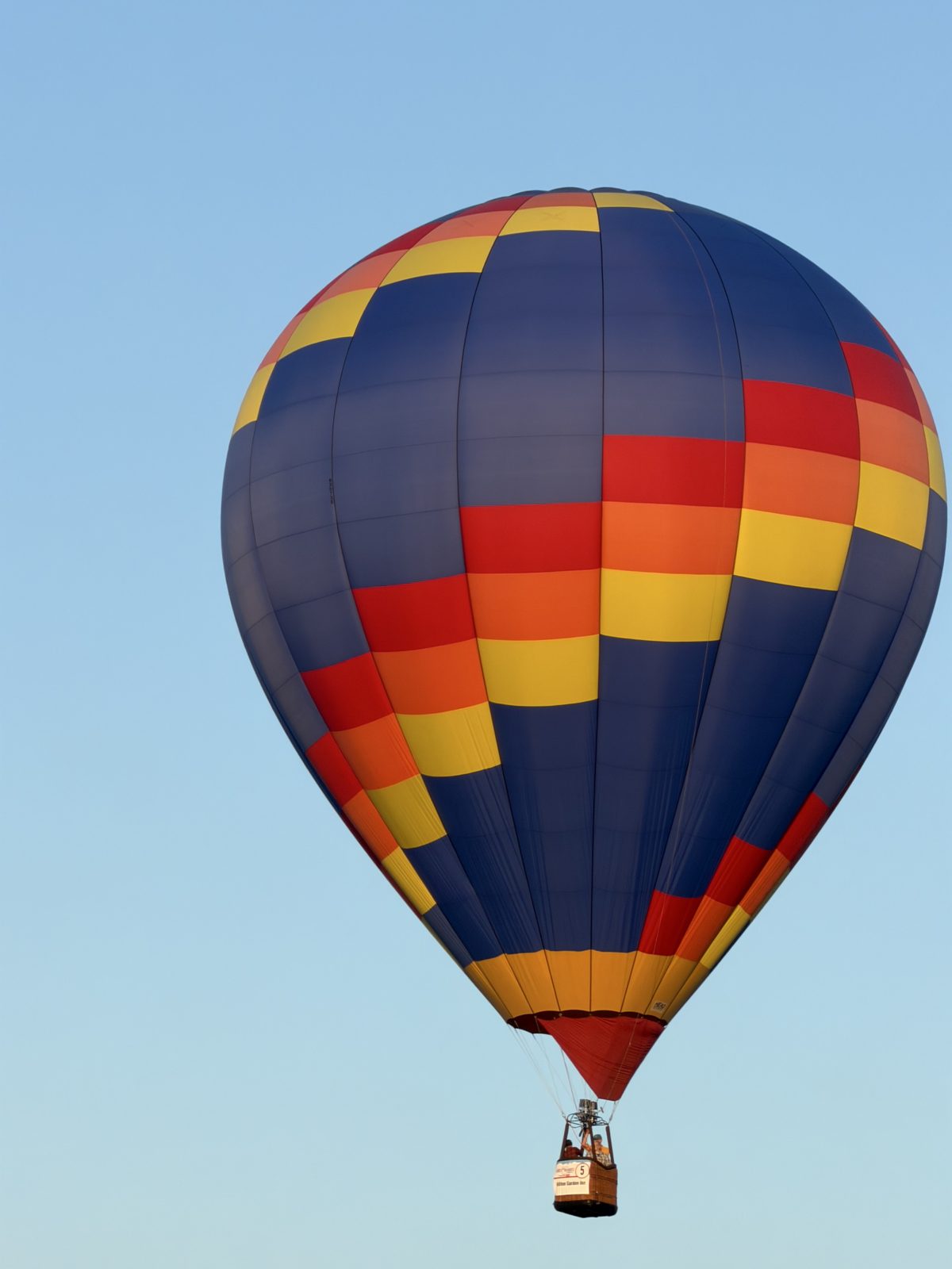 A hot air balloon in flight against a clear sky