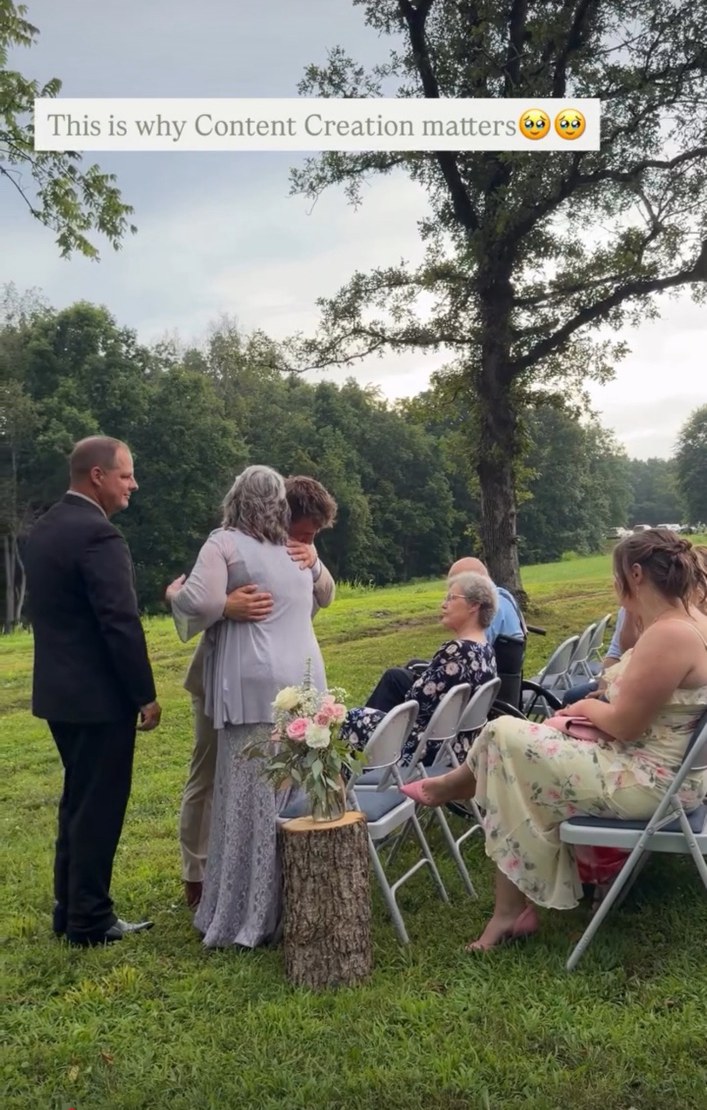 Guests embracing during an outdoor ceremony